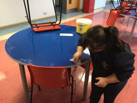 Assisting the kitchen staff by cleaning the tables after lunch.
